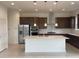 Modern kitchen featuring a center island, stainless steel appliances, and pendant lighting at 2861 Willowseed Ln, St Cloud, FL 34772