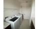 Laundry room featuring Samsung washer and dryer, tiled floor, and storage at 2861 Willowseed Ln, St Cloud, FL 34772