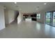 Open-concept living space with tile flooring, and view of the kitchen and sliding glass doors at 2861 Willowseed Ln, St Cloud, FL 34772