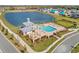 Aerial view of a resort-style pool with a pavilion, lounge chairs, and views of a serene lake at 2861 Willowseed Ln, St Cloud, FL 34772