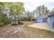 A view of the backyard with tractor, shed, and blue home at 2935 Apaloosa Trl, Deltona, FL 32738