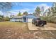 Charming one-story home featuring a well-manicured lawn and a spacious driveway with parking for multiple vehicles at 2935 Apaloosa Trl, Deltona, FL 32738