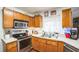 Updated kitchen with stainless steel appliances and oak cabinets at 2935 Apaloosa Trl, Deltona, FL 32738