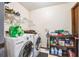 Well-equipped laundry room with modern washer and dryer, plus storage shelves at 2935 Apaloosa Trl, Deltona, FL 32738