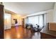 Open-concept living room with hardwood floors and natural light, showcasing a modern refrigerator at 2935 Apaloosa Trl, Deltona, FL 32738