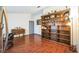 Spacious living room featuring a large wooden bookshelf and hardwood flooring at 2935 Apaloosa Trl, Deltona, FL 32738