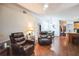 An open-concept living room showcasing hardwood floors and comfortable seating at 2935 Apaloosa Trl, Deltona, FL 32738