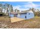 View of the back of the home featuring a patio, sliding glass door, and exterior hose connection at 2935 Apaloosa Trl, Deltona, FL 32738