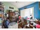 A storage room with unique blue and green walls, shelves, and organizers at 2935 Apaloosa Trl, Deltona, FL 32738