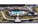 Aerial view of the community pool, amenity center, waterfront pier, and beautifully landscaped grounds at 3018 Jardin St, Kissimmee, FL 34741