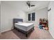 Bedroom with a neutral color scheme, a ceiling fan, and a shelf full of stuffed animals at 3018 Jardin St, Kissimmee, FL 34741
