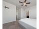 Inviting bedroom featuring soft carpet, ceiling fan, and a door to the en-suite bathroom at 3018 Jardin St, Kissimmee, FL 34741