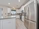 Modern kitchen featuring stainless steel appliances, sleek countertops, and ample cabinet space at 3018 Jardin St, Kissimmee, FL 34741