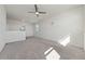 Bright upstairs loft area with plush carpeting and a ceiling fan, offering versatile living space at 3018 Jardin St, Kissimmee, FL 34741