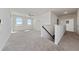 Upstairs loft space with neutral carpet, natural light, and a view of the staircase at 3018 Jardin St, Kissimmee, FL 34741