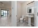 Cozy powder room featuring a pedestal sink and tile floors; steps visible from the open door at 3018 Jardin St, Kissimmee, FL 34741