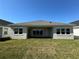 Spacious backyard featuring a covered patio and a well-maintained green lawn at 3108 Firethorn Cir, Daytona Beach, FL 32124
