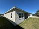 Back exterior view with well-maintained lawn and a covered patio for outdoor enjoyment at 3108 Firethorn Cir, Daytona Beach, FL 32124
