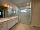 Modern bathroom showcasing a glass-enclosed shower, dual sinks, and stylish fixtures at 3108 Firethorn Cir, Daytona Beach, FL 32124