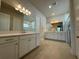 Elegant bathroom featuring dual vanities, sleek mirrors, and contemporary tile flooring at 3108 Firethorn Cir, Daytona Beach, FL 32124