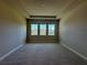 Bright and airy bedroom with a tray ceiling, plush carpet, and ample natural light from the windows at 3108 Firethorn Cir, Daytona Beach, FL 32124
