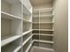 Walk-in closet with white shelving, maximizing storage space at 3108 Firethorn Cir, Daytona Beach, FL 32124