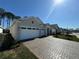 View of a charming single-story home with a two-car garage and a beautifully paved driveway at 3108 Firethorn Cir, Daytona Beach, FL 32124