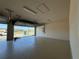 Spacious two-car garage featuring an open garage door and concrete flooring at 3108 Firethorn Cir, Daytona Beach, FL 32124