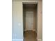 Entry hallway featuring tile flooring and neutral paint, leading to a closed white door at 3108 Firethorn Cir, Daytona Beach, FL 32124