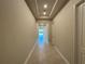 Long hallway with recessed lighting and tile flooring leading to a bright living area at 3108 Firethorn Cir, Daytona Beach, FL 32124
