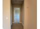Tiled hallway leading into a carpeted room, showcasing the seamless transition between spaces at 3108 Firethorn Cir, Daytona Beach, FL 32124
