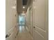 Hallway with neutral wall paint and tile floors, featuring a doorway at the end at 3108 Firethorn Cir, Daytona Beach, FL 32124