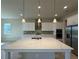 Modern kitchen boasts a large marble island and stainless steel appliances at 3108 Firethorn Cir, Daytona Beach, FL 32124