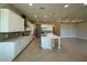 Open kitchen features white cabinets, stainless appliances, and large center island at 3108 Firethorn Cir, Daytona Beach, FL 32124