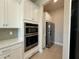 Modern oven and refrigerator with shaker cabinets and subway tile backsplash at 3108 Firethorn Cir, Daytona Beach, FL 32124