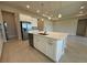 Bright kitchen island with stainless steel appliances and white cabinets at 3108 Firethorn Cir, Daytona Beach, FL 32124
