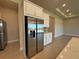 Contemporary stainless steel refrigerator with white cabinets and granite countertops at 3108 Firethorn Cir, Daytona Beach, FL 32124