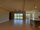 Bright, open-concept living room featuring large windows and tile floors at 3108 Firethorn Cir, Daytona Beach, FL 32124