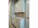 Mudroom with quartz countertops, modern cabinetry, and tile flooring at 3108 Firethorn Cir, Daytona Beach, FL 32124