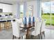 Elegant dining area with seating for six and sliding glass doors providing abundant natural light at 313 Castle Dr, Lake Alfred, FL 33850