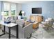 Cozy living room with plush seating, modern decor, and a wall-mounted TV for entertainment at 313 Castle Dr, Lake Alfred, FL 33850