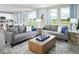 Open-concept living room with comfortable seating and large windows showcasing scenic views at 313 Castle Dr, Lake Alfred, FL 33850