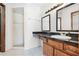 Bathroom with double sinks, granite countertop, and tiled shower at 3141 Wainwright St, Deltona, FL 32738