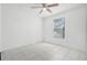 Bright bedroom featuring tile floors, a ceiling fan, and a window that fills the space with natural light at 3141 Wainwright St, Deltona, FL 32738