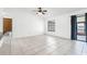Bright living room with tile floors, ceiling fan, and sliding glass doors to the outdoor area at 3141 Wainwright St, Deltona, FL 32738