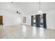 Spacious living room featuring tile floors, large windows, and ceiling fan, blending comfort with natural light and ventilation at 3141 Wainwright St, Deltona, FL 32738