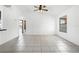 Bright living room with tile flooring, offering a neutral palette and versatile space for various furniture arrangements and decor styles at 3141 Wainwright St, Deltona, FL 32738