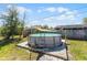 Backyard with a pool on a wood patio with a ladder and a shade covering at 3141 Wainwright St, Deltona, FL 32738
