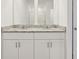 Stylish bathroom featuring a double vanity, granite countertops, and ample mirror space at 317 Castle Dr, Lake Alfred, FL 33850