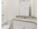 Bright bathroom featuring a granite countertop, white cabinets, and a shower-tub combo with white tiled walls at 317 Castle Dr, Lake Alfred, FL 33850